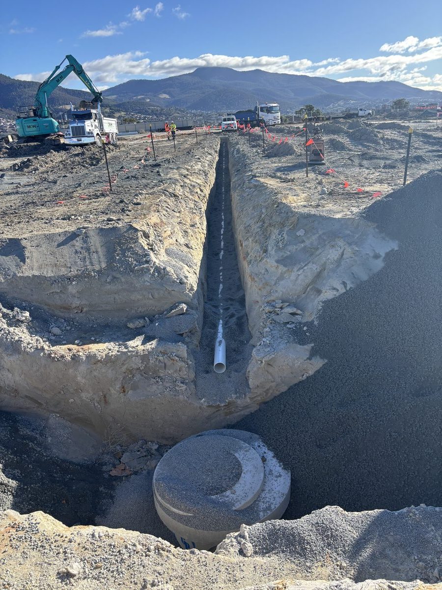 Underground drainage installation with Mt Wellington backdrop — Hobart